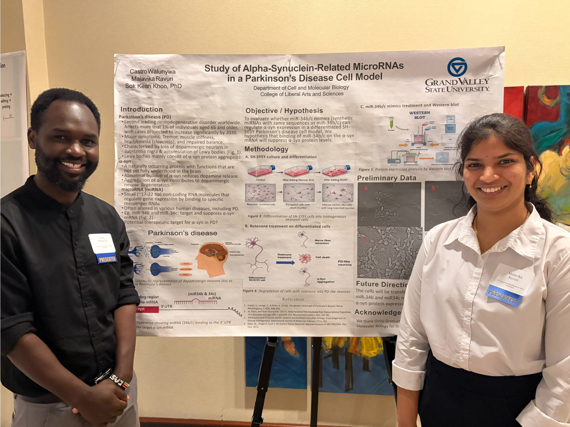 Castro and Malavika presenting research poster.